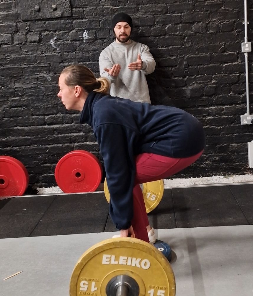 Kieron coaching Jessica through a deadlift at Titan