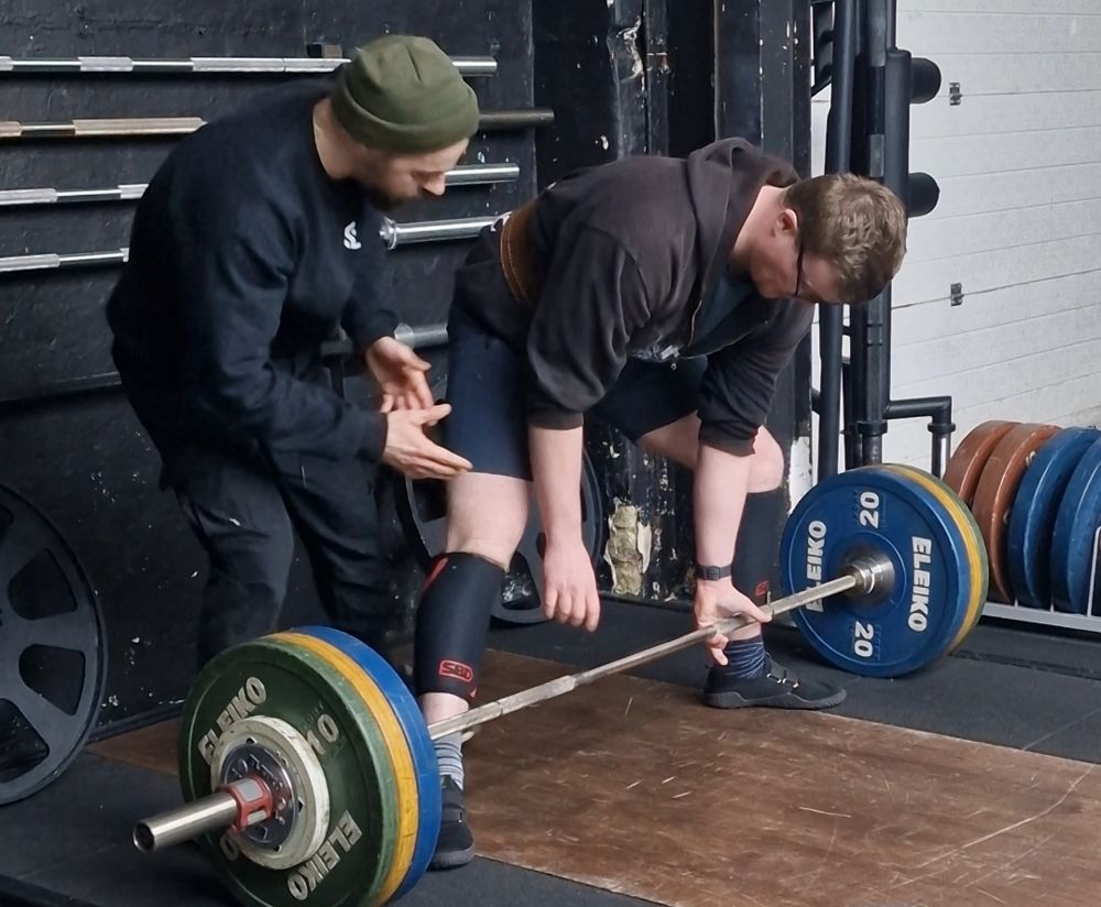 Kieron cueing Will's deadlift set-up at Titan